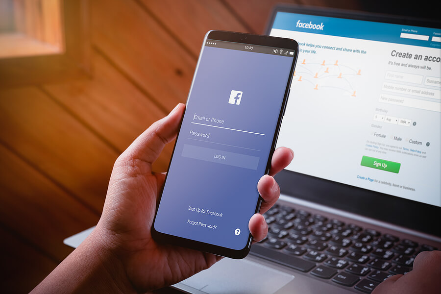 Laptop and mobile phone with facebook open