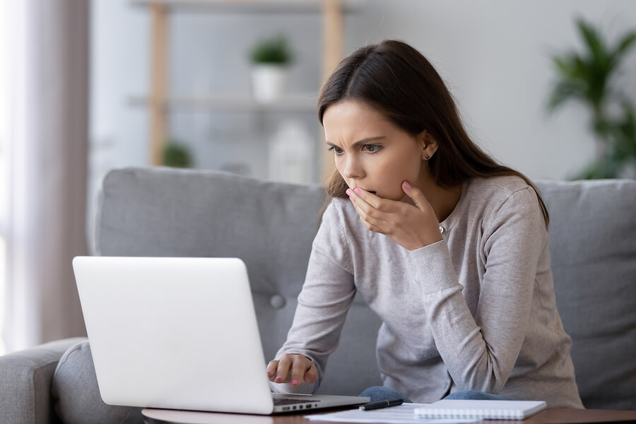 Stressed out woman reading on laptop