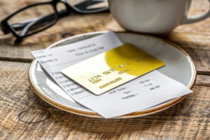 Golden credit card ready for the bill at the table